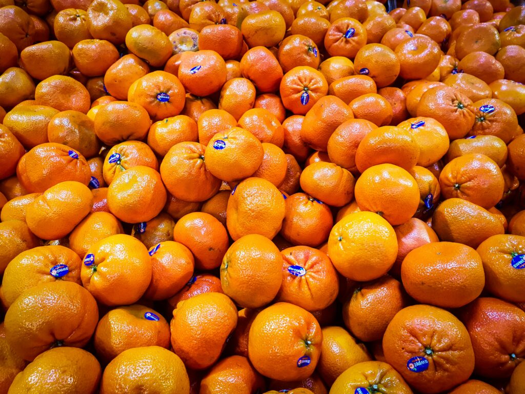 A vibrant pile of fresh oranges, perfect for healthy eating and a burst of tropical flavor.